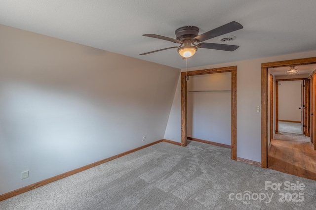 unfurnished bedroom featuring light colored carpet, ceiling fan, and a closet