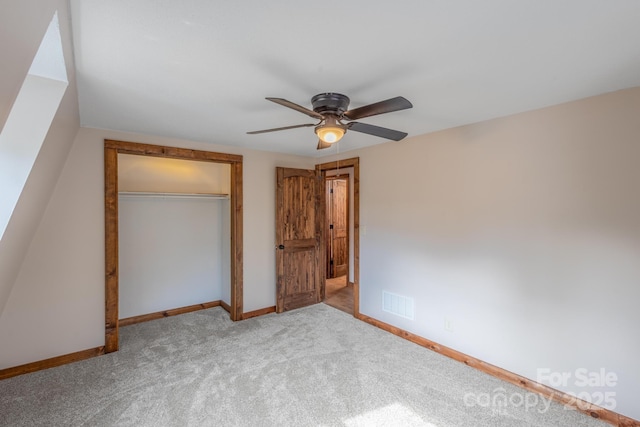 unfurnished bedroom featuring carpet, ceiling fan, and a closet