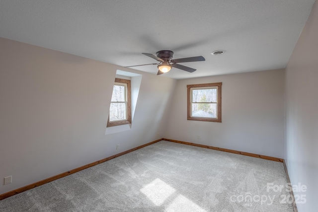 unfurnished room with carpet, a wealth of natural light, and ceiling fan