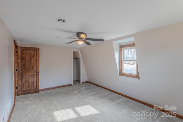 unfurnished bedroom with light carpet, a closet, and ceiling fan