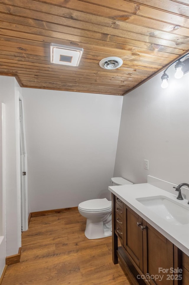 bathroom featuring vanity, wood ceiling, toilet, and hardwood / wood-style flooring