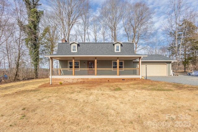 farmhouse inspired home with a garage, a front yard, and covered porch