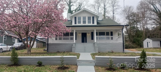 view of front of home featuring covered porch and a chimney