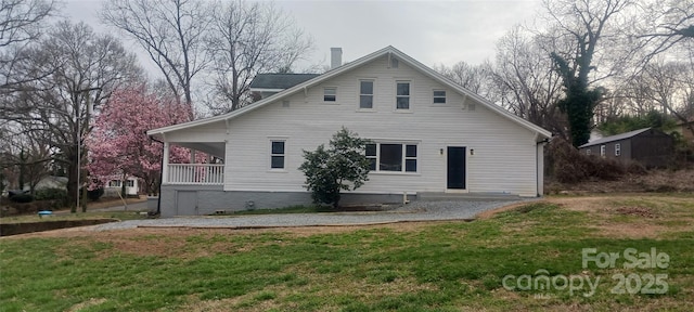 back of property featuring a yard and a chimney