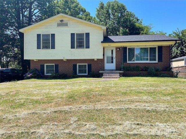 tri-level home with a front yard