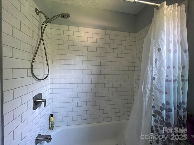 bathroom with shower / bath combo with shower curtain