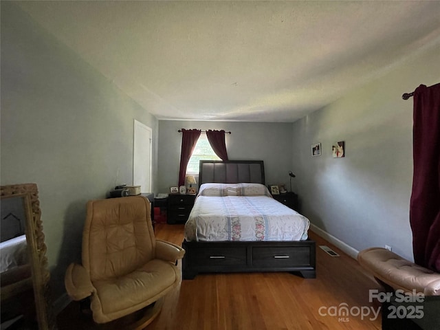 bedroom with hardwood / wood-style floors