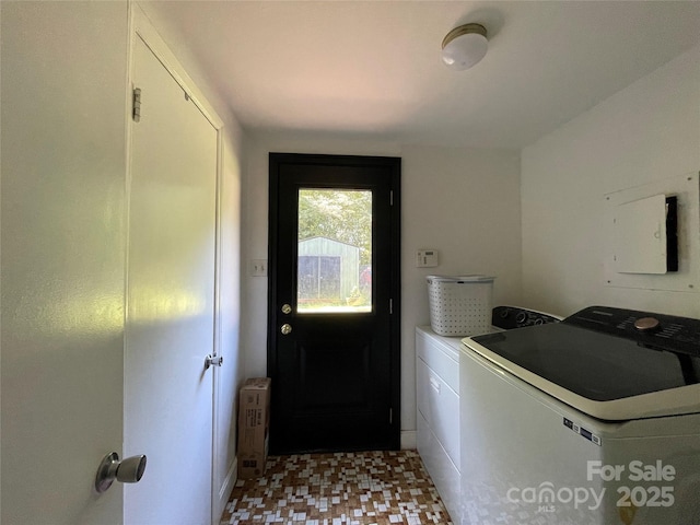 laundry room featuring washing machine and clothes dryer and radiator heating unit