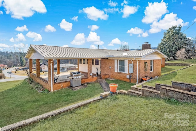 back of house with a patio and a yard