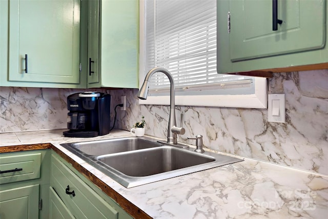 kitchen with sink, decorative backsplash, and green cabinets