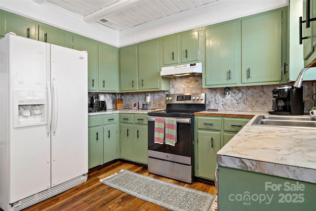 kitchen featuring electric stove, dark wood-type flooring, tasteful backsplash, white fridge with ice dispenser, and green cabinetry