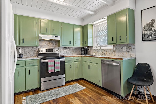 kitchen with sink, green cabinetry, dark hardwood / wood-style flooring, beamed ceiling, and stainless steel appliances