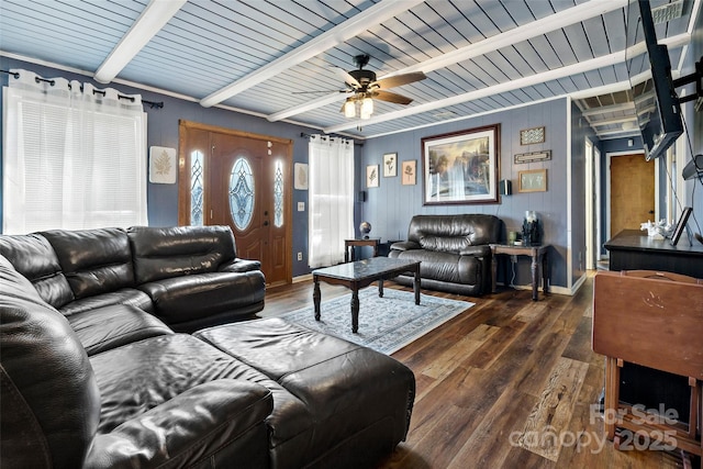 living room featuring ceiling fan, dark wood-type flooring, and beamed ceiling