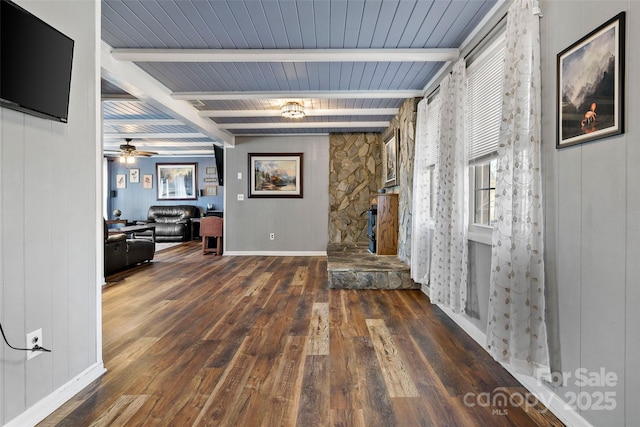 living room with beam ceiling, dark wood-type flooring, wooden ceiling, and ceiling fan