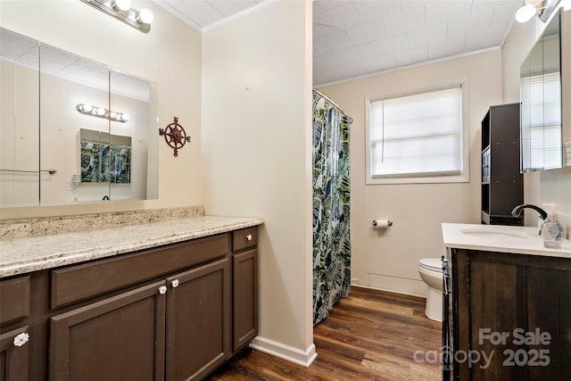 bathroom with crown molding, vanity, toilet, and hardwood / wood-style floors