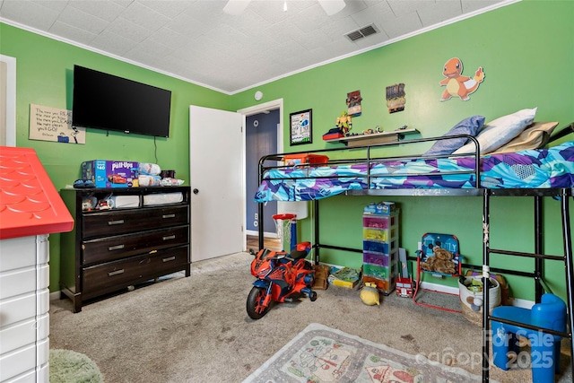 carpeted bedroom with ceiling fan and ornamental molding