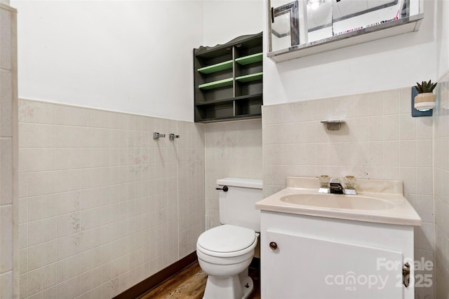 bathroom featuring hardwood / wood-style flooring, vanity, tile walls, and toilet