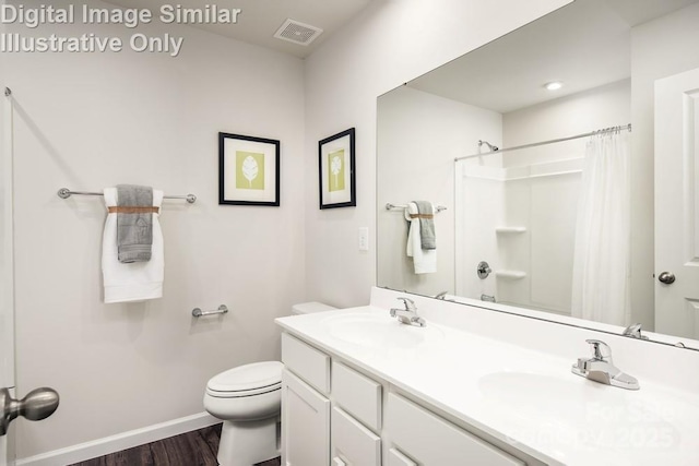 bathroom featuring hardwood / wood-style flooring, vanity, toilet, and curtained shower