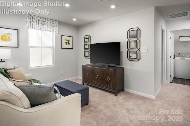 living room with washer / dryer and light carpet