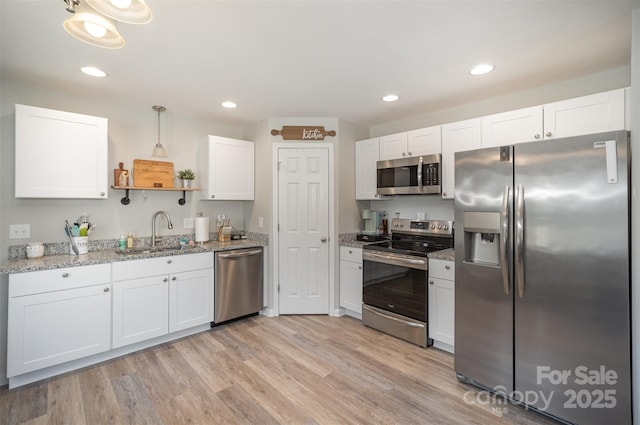 kitchen featuring white cabinetry, stainless steel appliances, and sink