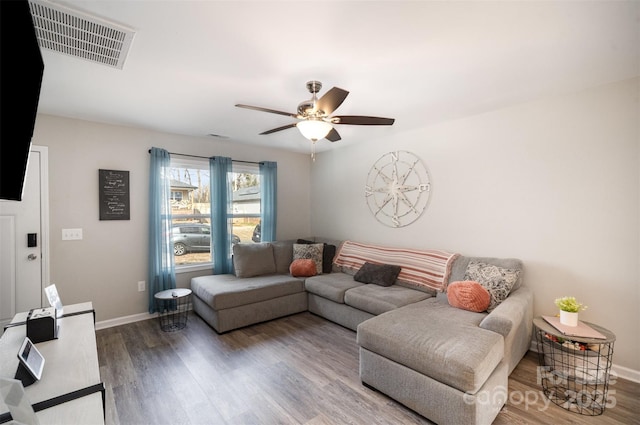 living room with wood-type flooring and ceiling fan