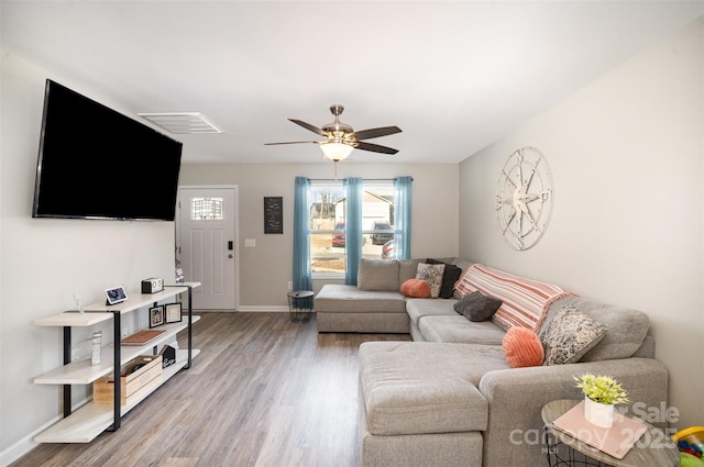 living room with hardwood / wood-style floors and ceiling fan