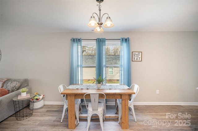 dining area featuring a chandelier and light wood-type flooring