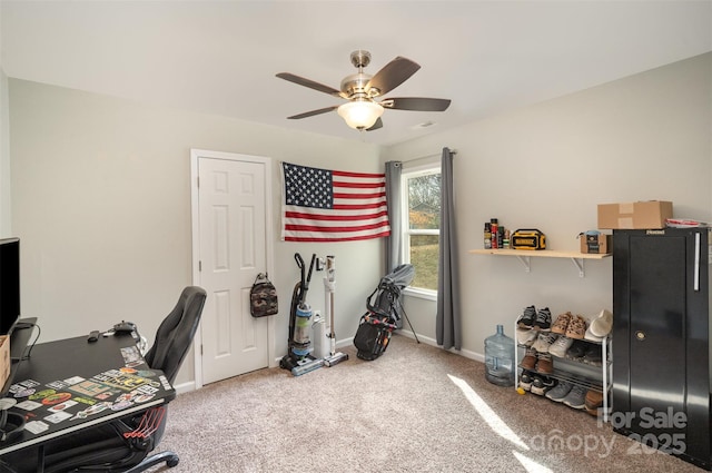 carpeted office space with ceiling fan