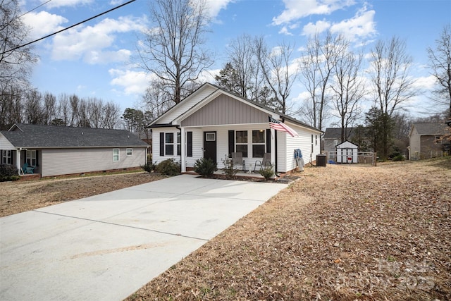 view of front of property with a storage unit and covered porch