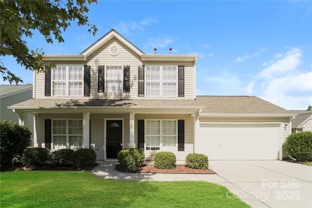 front facade featuring a porch, a garage, and a front yard