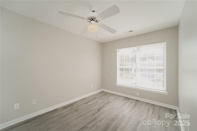 spare room featuring ceiling fan and light wood-type flooring