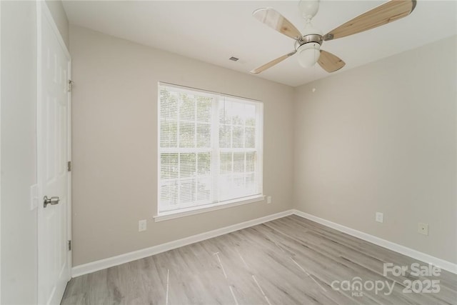 empty room with light hardwood / wood-style flooring and ceiling fan