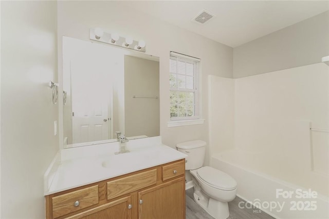 full bathroom featuring vanity, shower / washtub combination, and toilet