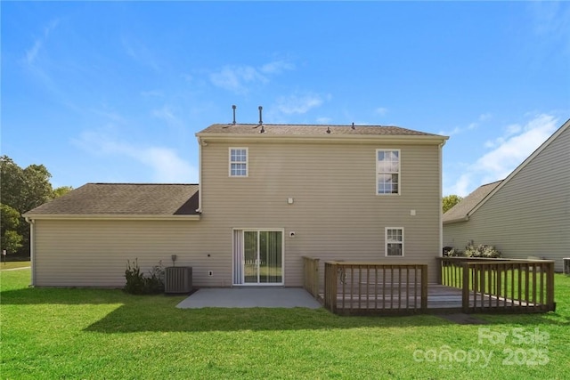 back of house with cooling unit, a yard, a wooden deck, and a patio