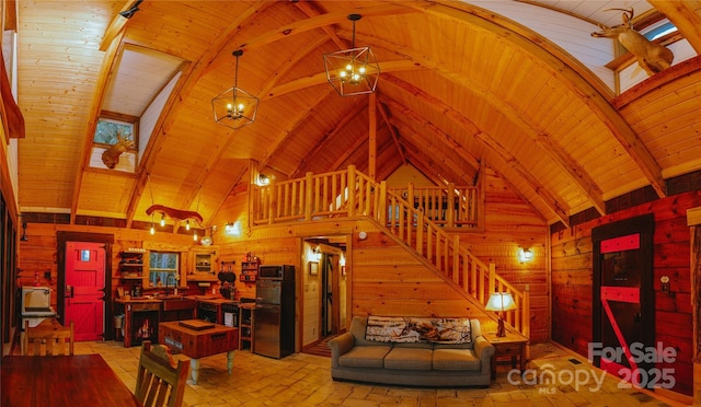 living room featuring an inviting chandelier, wooden walls, and wooden ceiling