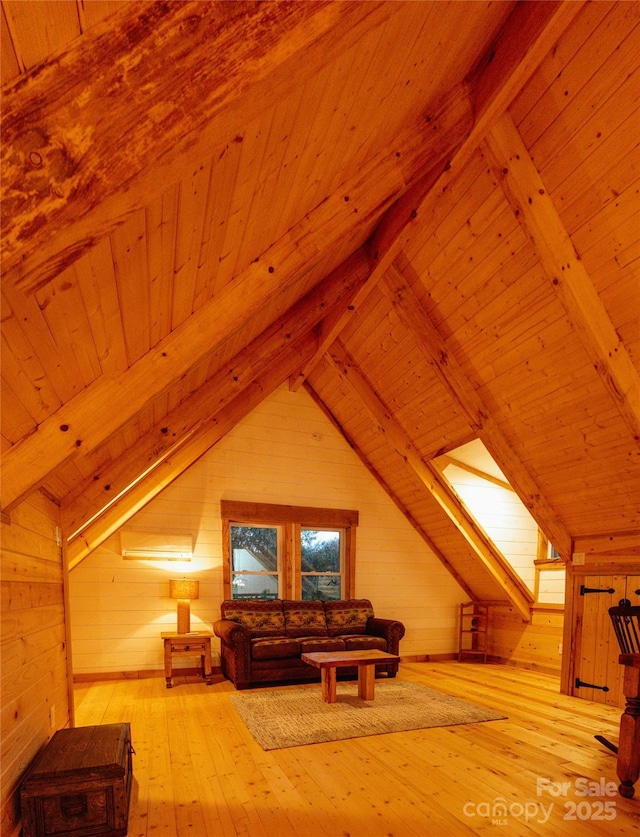 additional living space with hardwood / wood-style flooring, wood ceiling, lofted ceiling with beams, and wood walls