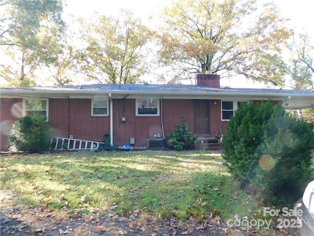 rear view of property featuring a lawn