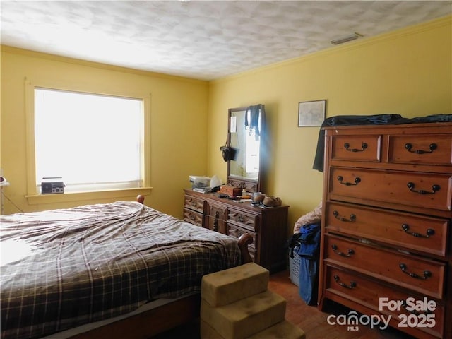 bedroom with ornamental molding