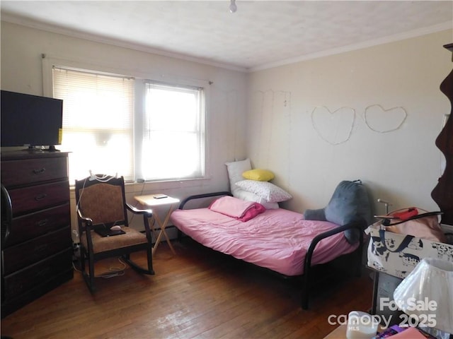 bedroom featuring hardwood / wood-style flooring and ornamental molding