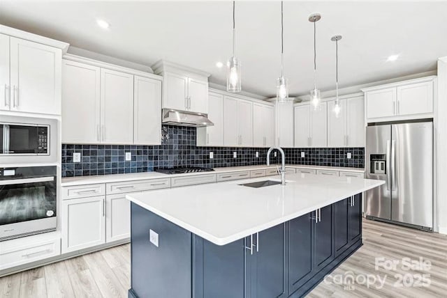 kitchen featuring sink, hanging light fixtures, stainless steel refrigerator with ice dispenser, built in microwave, and oven