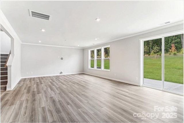 unfurnished living room with ornamental molding and light hardwood / wood-style flooring