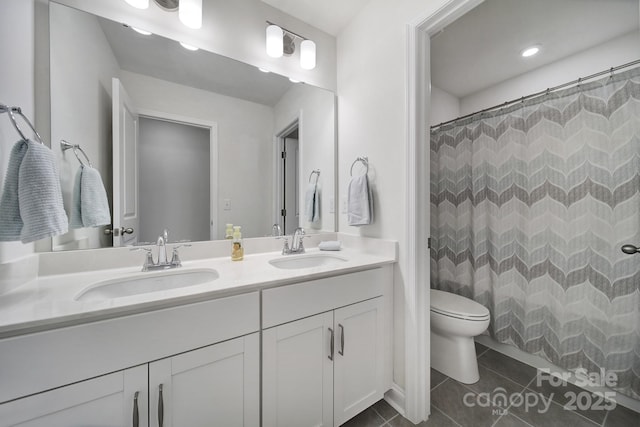 bathroom featuring vanity, tile patterned floors, toilet, and walk in shower