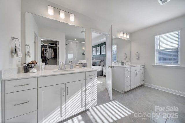 bathroom with vanity, tile patterned floors, and a shower with shower door