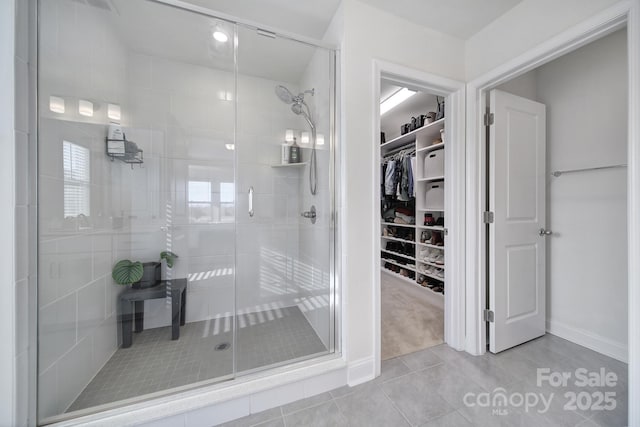 bathroom with tile patterned floors and walk in shower