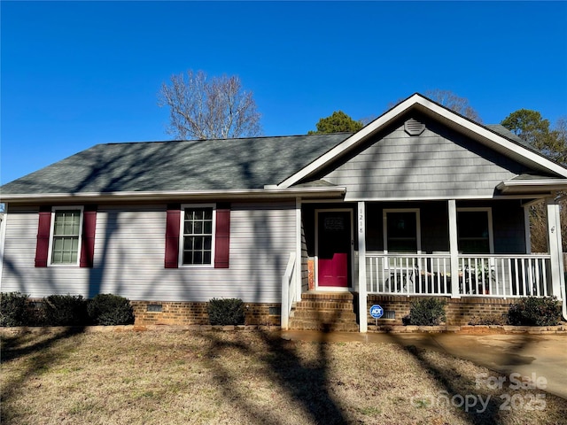 ranch-style house featuring a front yard and a porch