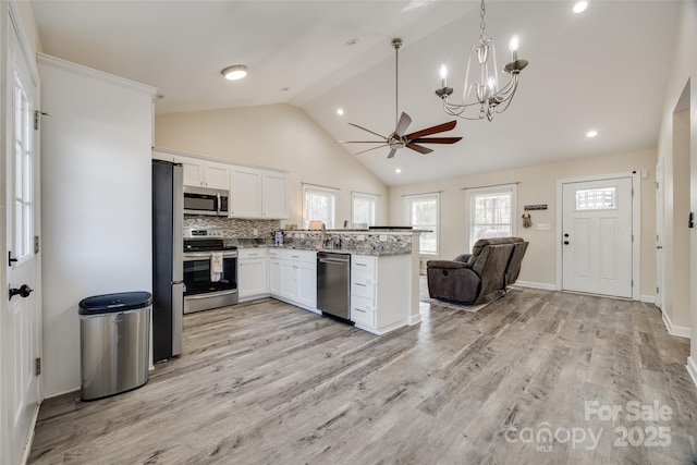 kitchen featuring white cabinetry, light hardwood / wood-style flooring, stainless steel appliances, and a healthy amount of sunlight