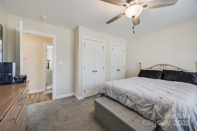 bedroom featuring multiple closets, light colored carpet, and ceiling fan