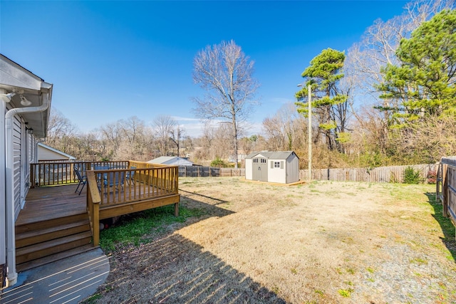 view of yard with a shed and a deck