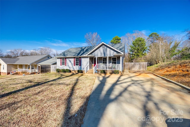 ranch-style house with a porch and a front yard