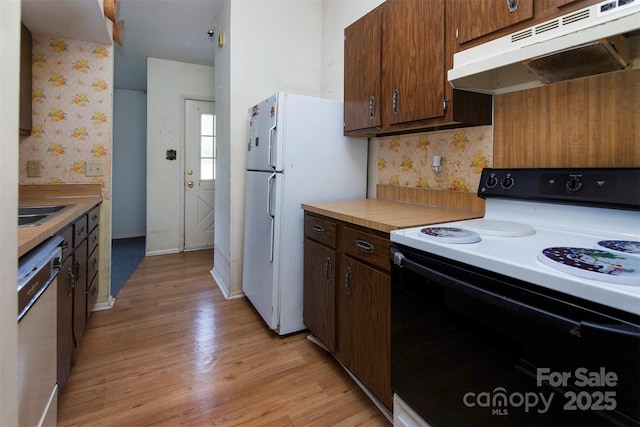 kitchen featuring light hardwood / wood-style flooring, backsplash, electric range, white refrigerator, and stainless steel dishwasher